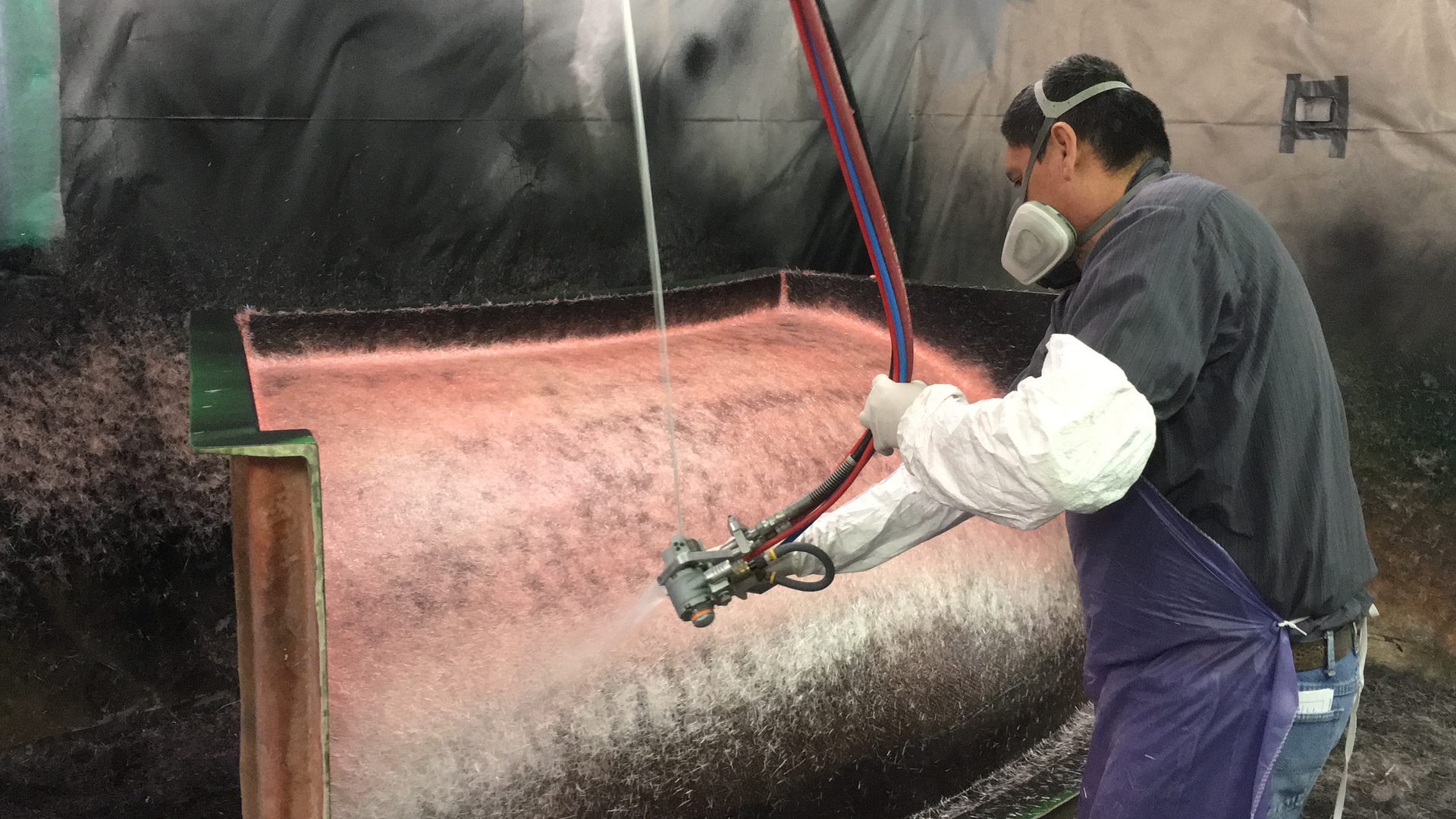 Pro-Glas technician applying chopped fiberglass to production tooling