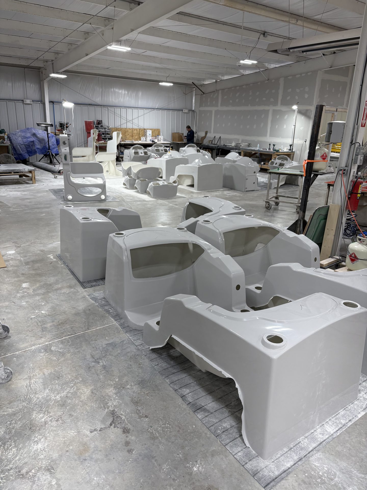 Gray molded shells lined up across the production floor